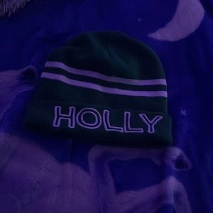 Beanie, green, white wording saying “HOLLY”